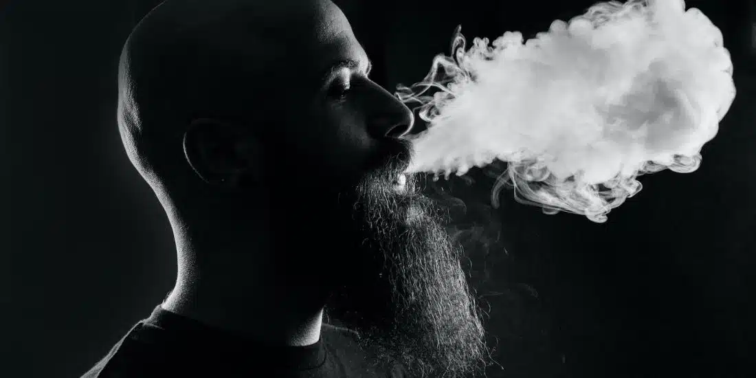 man smoking with black background