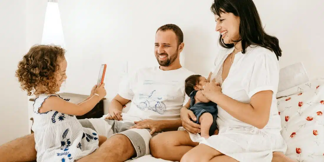 man in white crew neck t-shirt sitting beside woman in white crew neck t-shirt